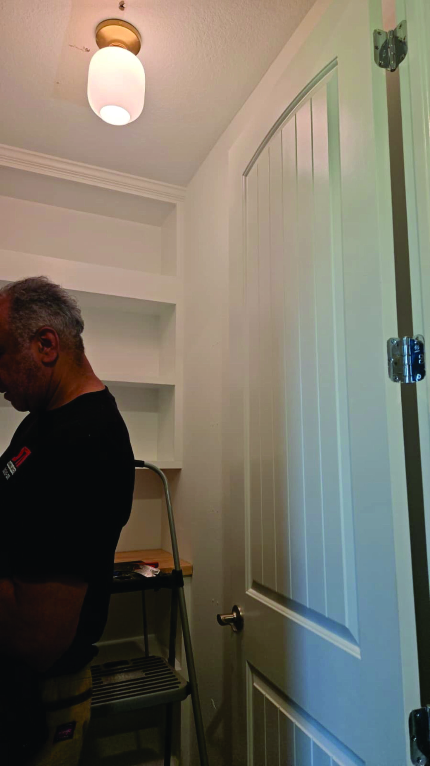 Modern walk-in pantry featuring custom shelving and cabinetry.