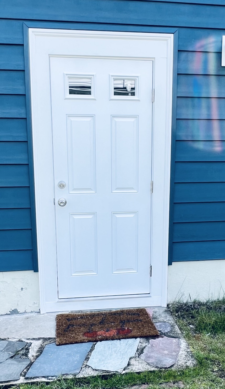 Modern front entry door installed on a residential home.