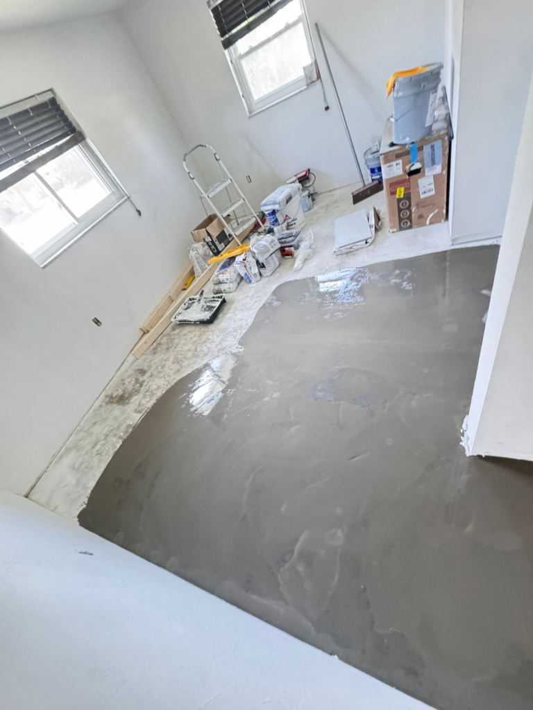 Flooring installer preparing a subfloor before installation.
